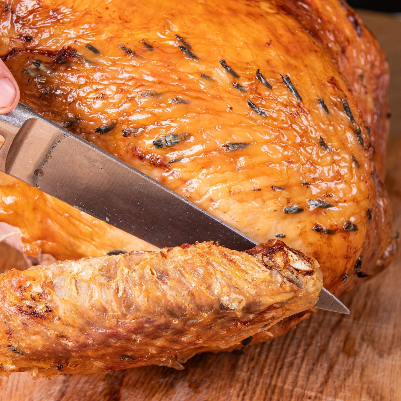 Cutting the leg away from a roast Shropshire Bronze with a carving knife